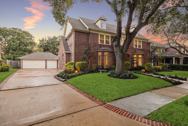 view of front of house featuring a yard and a garage