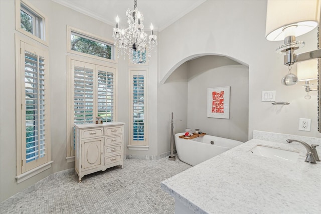 bathroom featuring vanity, an inviting chandelier, crown molding, tile patterned flooring, and a washtub