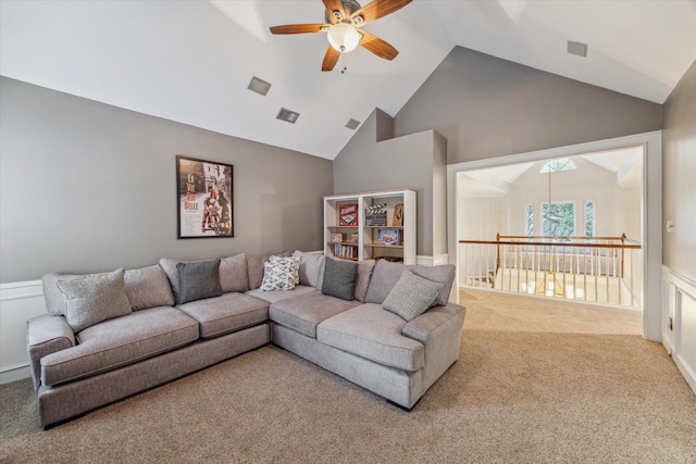 carpeted living room featuring ceiling fan and vaulted ceiling