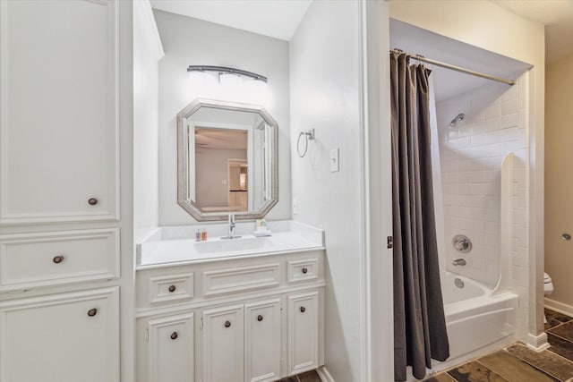 full bathroom featuring shower / tub combo with curtain, vanity, and toilet