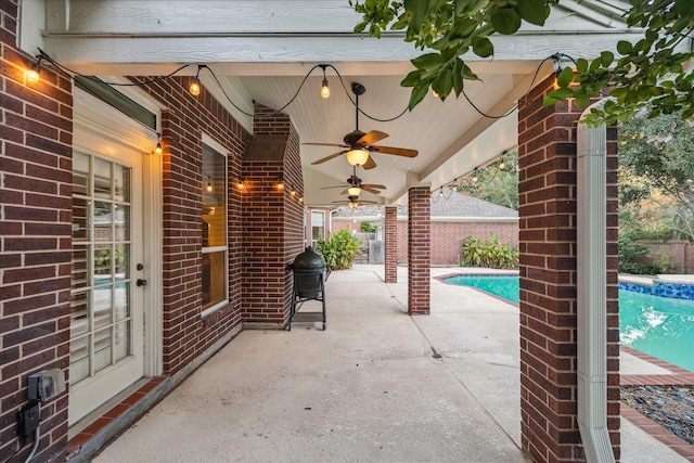 view of patio featuring a fenced in pool, area for grilling, and ceiling fan