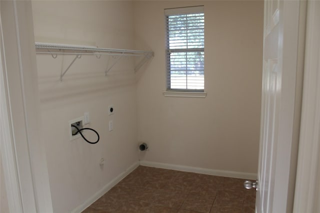 laundry area featuring washer hookup, dark tile patterned floors, plenty of natural light, and electric dryer hookup