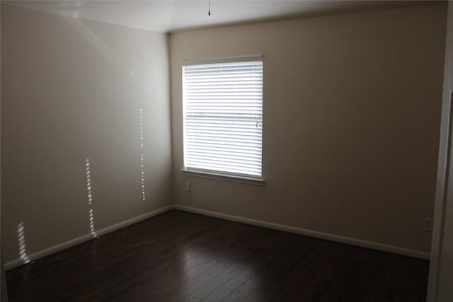 spare room featuring dark hardwood / wood-style floors