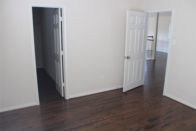 spare room featuring dark wood-type flooring