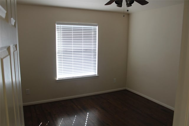 spare room featuring ceiling fan and dark wood-type flooring