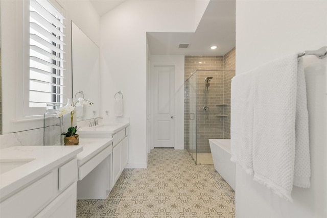 bathroom featuring vanity and shower with separate bathtub