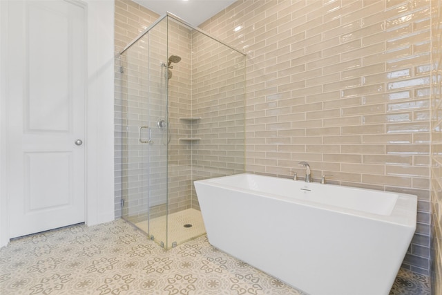 bathroom featuring tile walls, tile patterned floors, and plus walk in shower