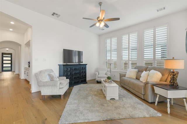 living room featuring light hardwood / wood-style flooring and ceiling fan