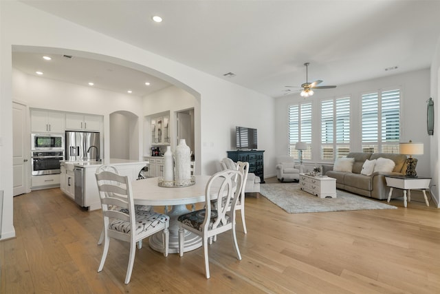 dining room with ceiling fan and light hardwood / wood-style floors