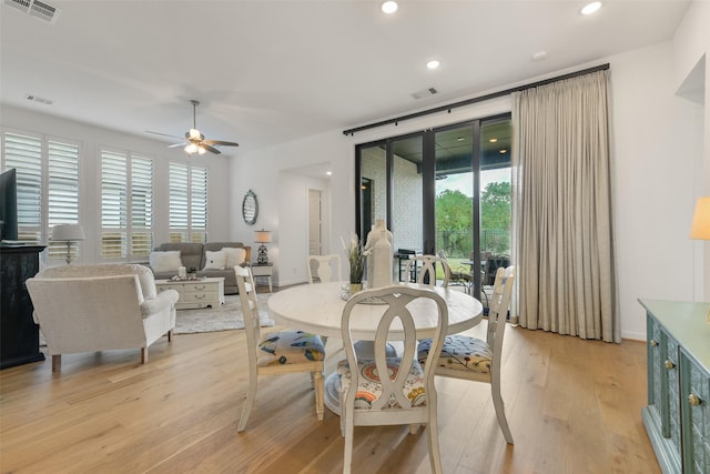 dining space with ceiling fan and light hardwood / wood-style floors