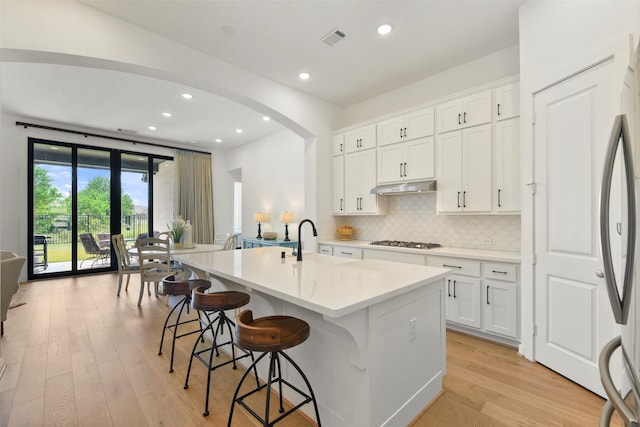 kitchen featuring white cabinetry, sink, an island with sink, and stainless steel appliances