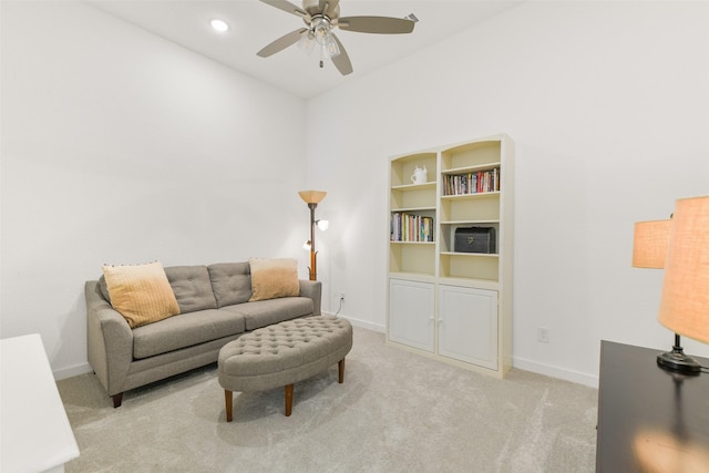 carpeted living room with ceiling fan