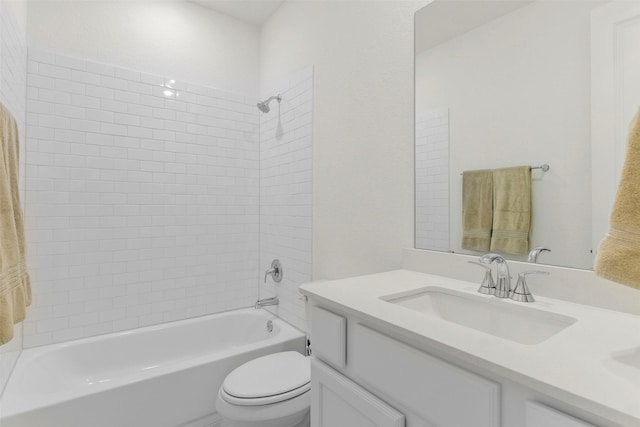 full bathroom featuring toilet, vanity, and tiled shower / bath