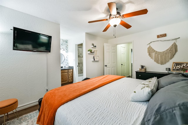 bedroom featuring hardwood / wood-style flooring, ensuite bath, and ceiling fan