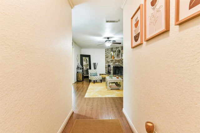 hallway featuring hardwood / wood-style flooring and ornamental molding