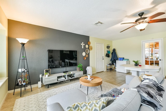 tiled living room featuring ceiling fan