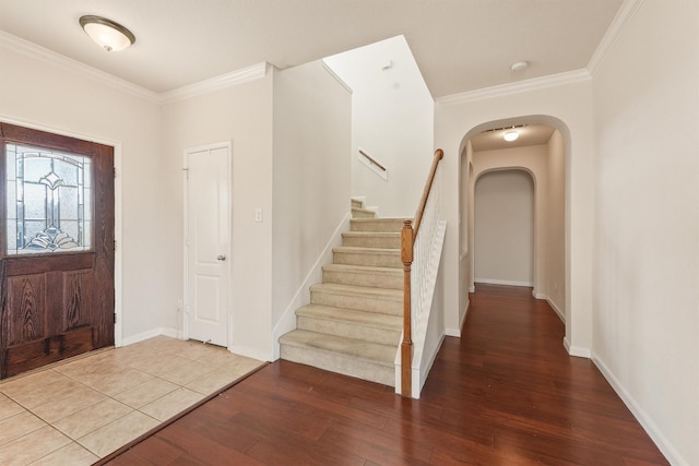 foyer entrance with hardwood / wood-style flooring and ornamental molding