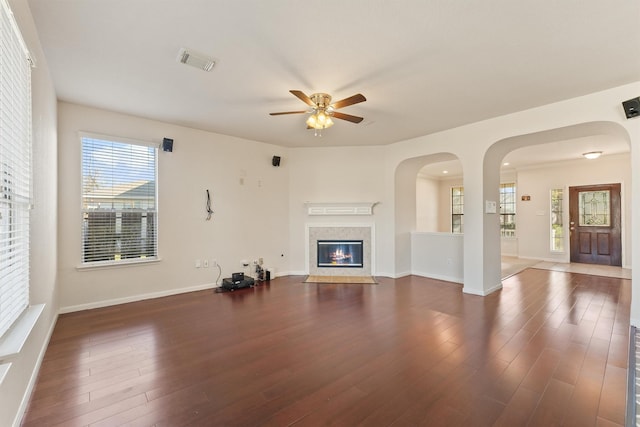 unfurnished living room with ceiling fan and dark hardwood / wood-style floors