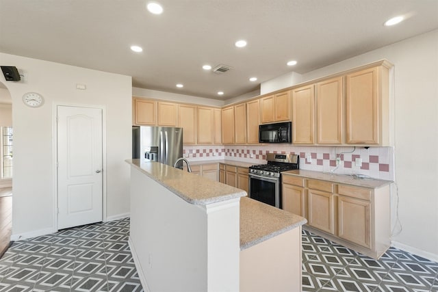 kitchen featuring a center island with sink, backsplash, stainless steel appliances, and light brown cabinetry