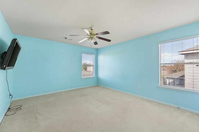 unfurnished room featuring light carpet and ceiling fan