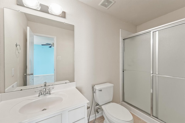 bathroom with an enclosed shower, vanity, ceiling fan, tile patterned flooring, and toilet