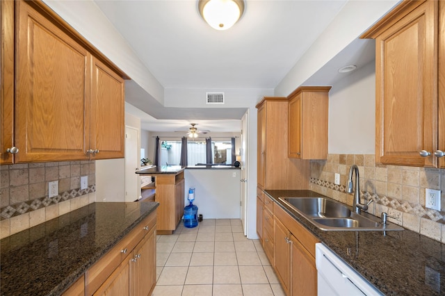 kitchen featuring backsplash, sink, ceiling fan, light tile patterned floors, and kitchen peninsula