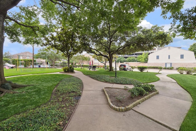 view of community with a lawn and a playground