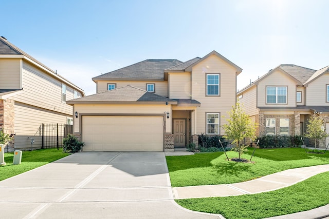 view of front of property with a front yard and a garage