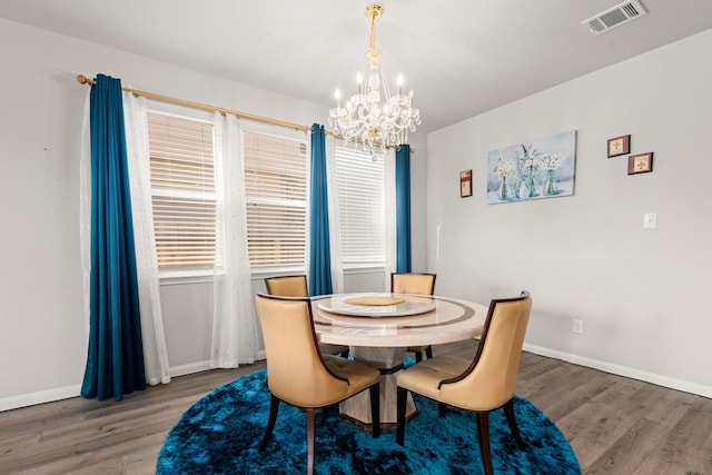 dining room featuring a chandelier and wood-type flooring