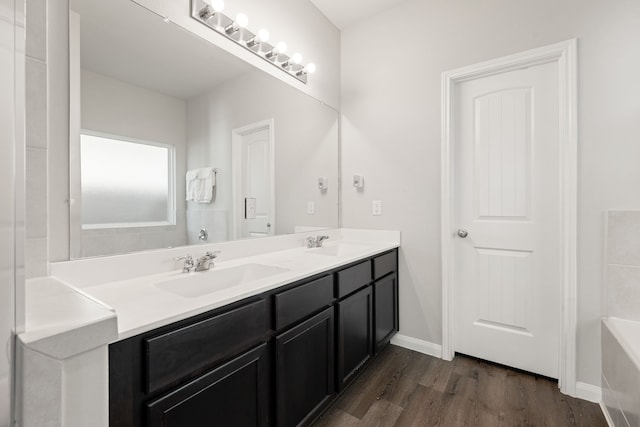 bathroom featuring a bathtub, hardwood / wood-style flooring, and vanity