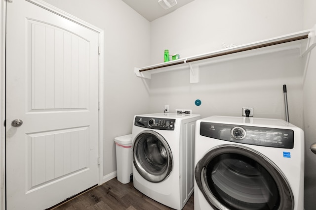 laundry area with dark hardwood / wood-style flooring and washing machine and dryer