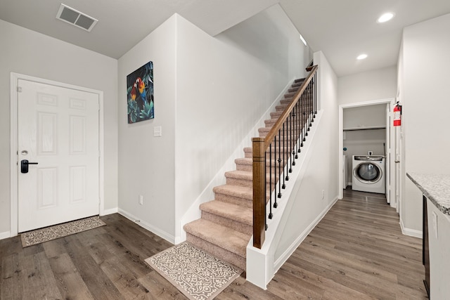 entrance foyer with dark hardwood / wood-style flooring and washer / dryer