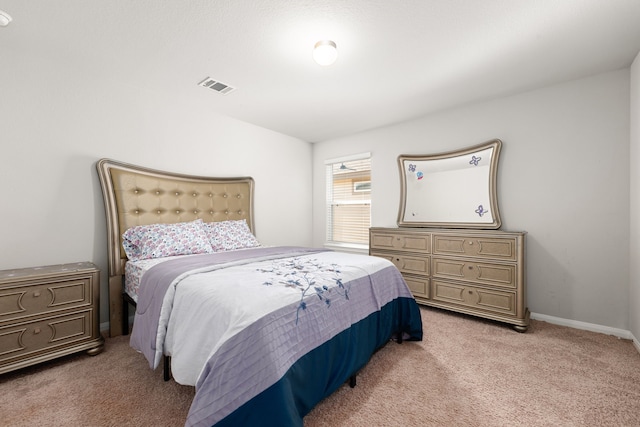 bedroom with light colored carpet