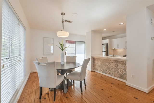 dining area featuring light hardwood / wood-style floors and sink