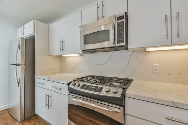 kitchen with white cabinetry, light hardwood / wood-style flooring, and stainless steel appliances