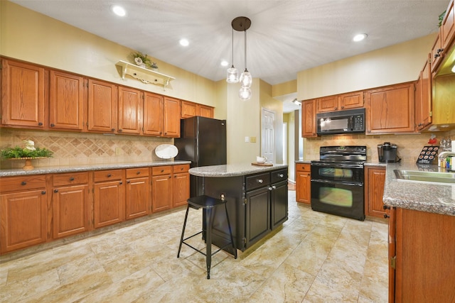 kitchen with a center island, backsplash, black appliances, sink, and hanging light fixtures