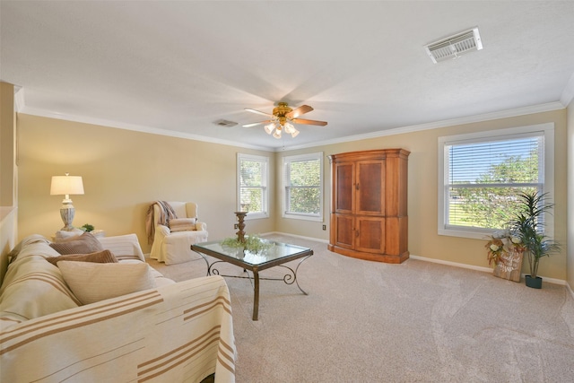 carpeted living room with plenty of natural light, crown molding, and ceiling fan