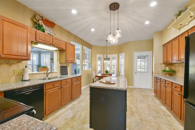 kitchen with pendant lighting, backsplash, a center island, and black appliances