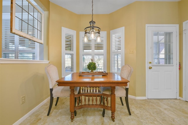 dining area featuring an inviting chandelier