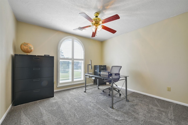 carpeted office with a textured ceiling and ceiling fan