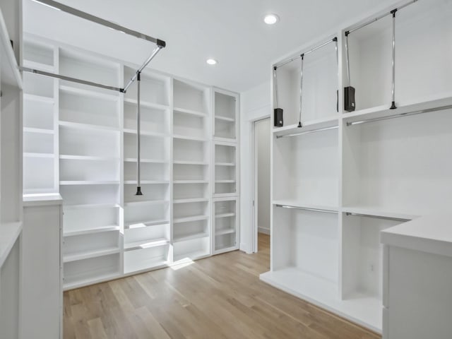 spacious closet featuring light hardwood / wood-style flooring