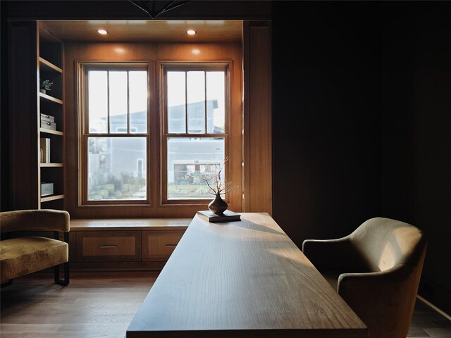 home office featuring built in desk, built in features, and wood-type flooring