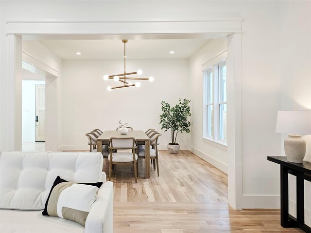 dining space with a chandelier and light hardwood / wood-style flooring