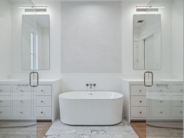 bathroom featuring vanity and shower with separate bathtub