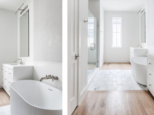 bathroom featuring vanity, wood-type flooring, and separate shower and tub