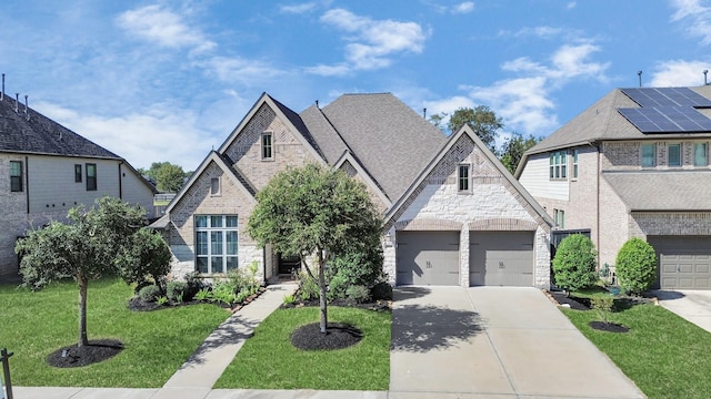 view of front of property featuring a front lawn and a garage