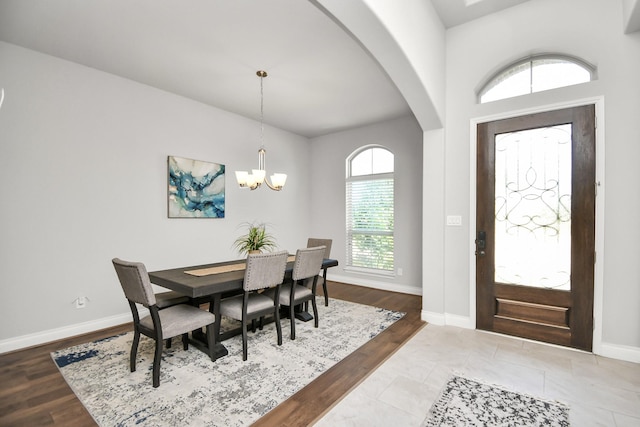 dining area with a chandelier and wood-type flooring