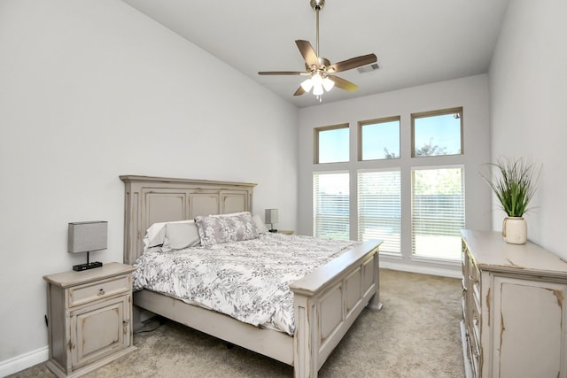 bedroom with light carpet, a high ceiling, and ceiling fan