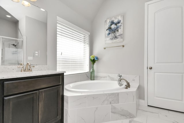 bathroom featuring plus walk in shower, vanity, and vaulted ceiling