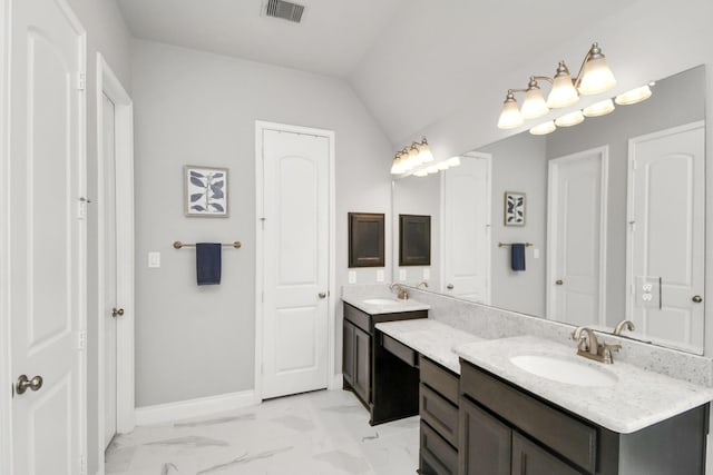 bathroom with vanity and vaulted ceiling